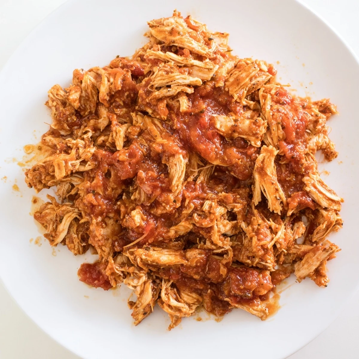 Juicy, shredded Slow Cooker Salsa Chicken, ready to fill tacos and served with a vibrant salsa.