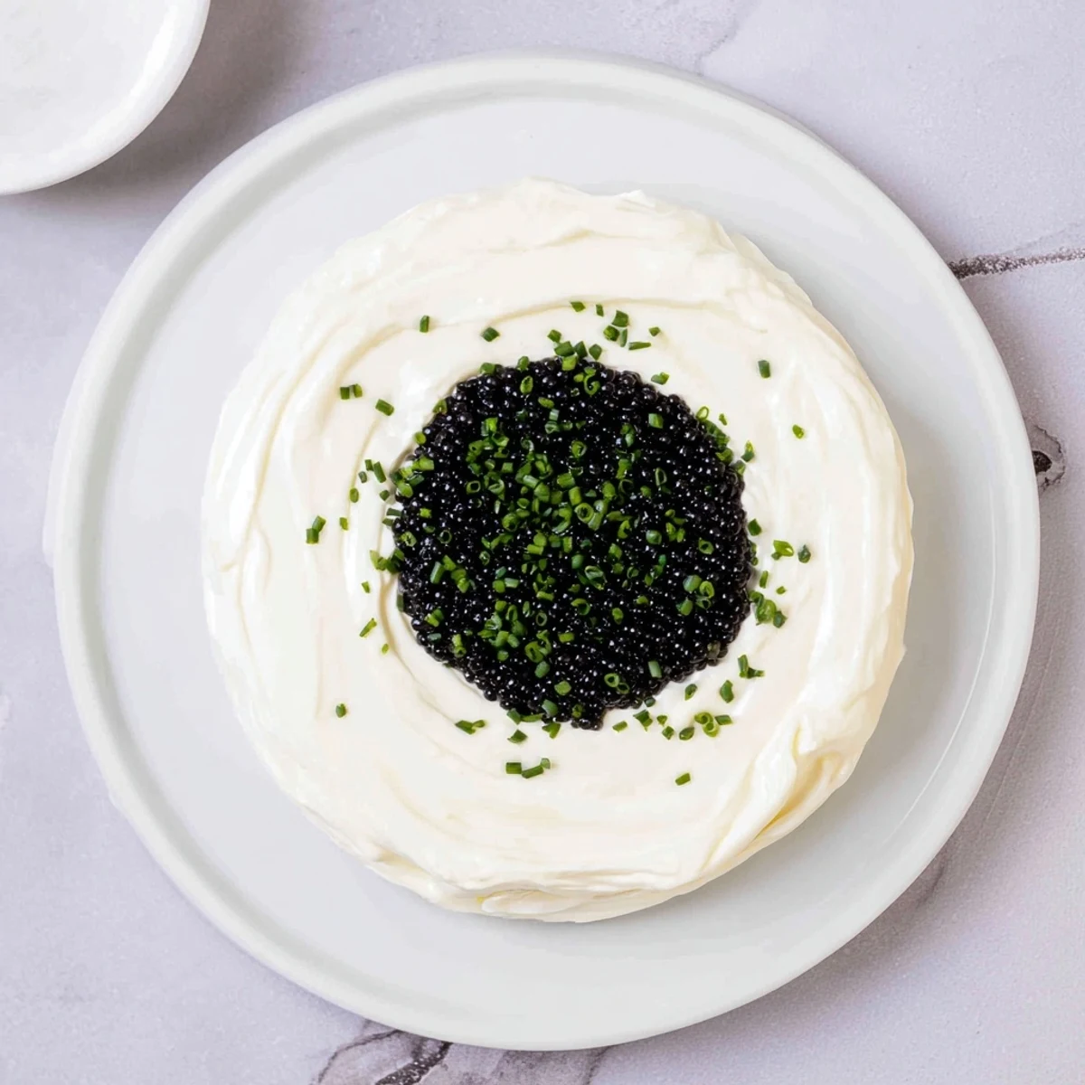 Creamy Diamond Inlay appetizer featuring a decadent caviar diamond ready to serve with crispy blinis.