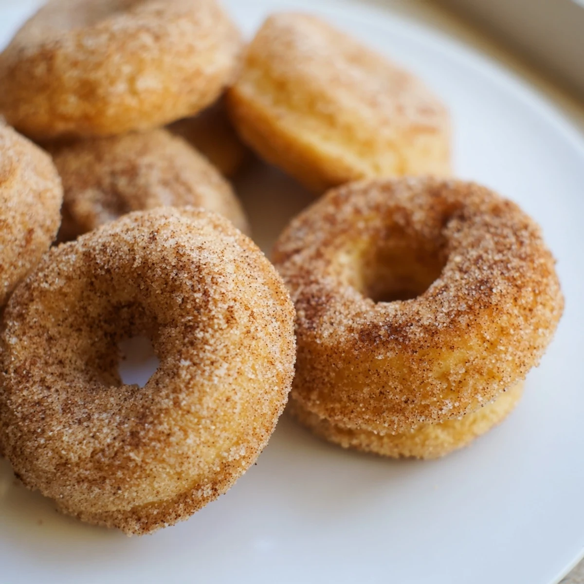 Warm, freshly baked cinnamon-sugar donuts ready to be enjoyed, a sweet American breakfast favorite.
