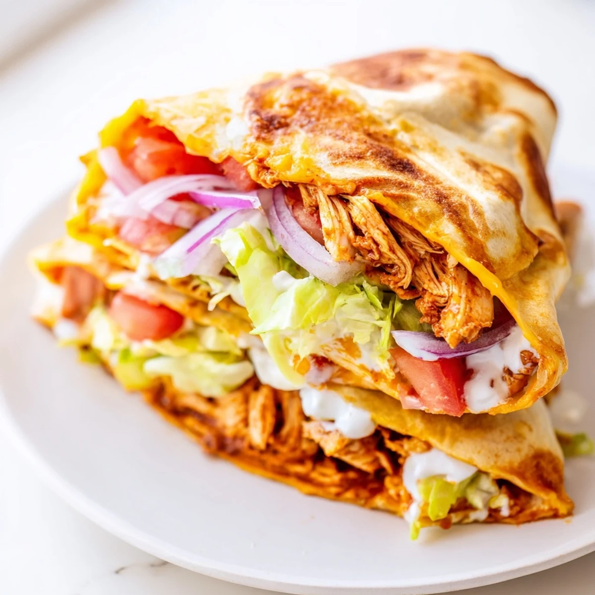 Spicy, shredded chicken inside a warm, crisp Buffalo Chicken Wrap, perfect for a quick and easy dinner idea.