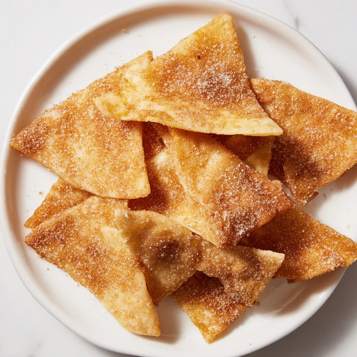 Delectable cinnamon sugar tortilla chips, showing crispy texture and dusted with sweet cinnamon.