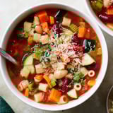 A warm bowl of the vibrant Veggie-Packed Minestrone Christmas Pasta Pot, with fresh parsley and cheese.