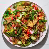 A delicious Fattoush Crunch Salad ready to eat, featuring bright greens, tomatoes and a flavorful lemony dressing.