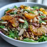 Hearty Farro Salad Bowl with Fennel, Oranges & Almonds tossed with greens and a zesty vinaigrette.