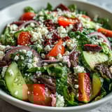A Mediterranean Green Salad Bowl tossed with tangy Greek dressing, ready for a quick vegetarian lunch or a healthy dinner side.