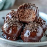 Hojicha Truffles on a platter, dusted with roasted green tea powder, offering a refined after-dinner treat.