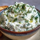 Vibrant skyr tzatziki dip, boasting fresh dill and crisp cucumber, perfect with pita.