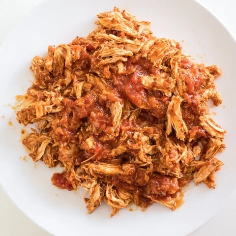 Juicy, shredded Slow Cooker Salsa Chicken, ready to fill tacos and served with a vibrant salsa.