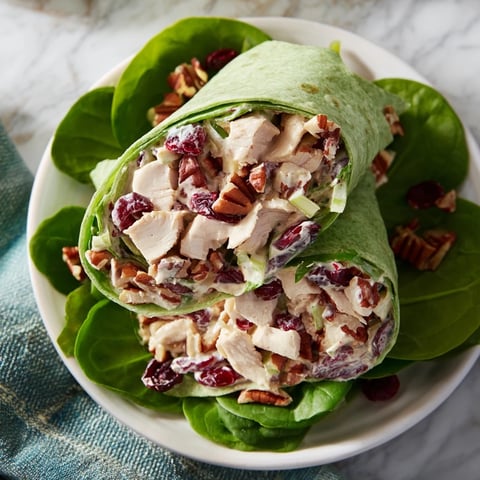 Festive Cranberry Pecan Chicken Salad Christmas Wrap, filled with colorful fruit and crunchy pecans.