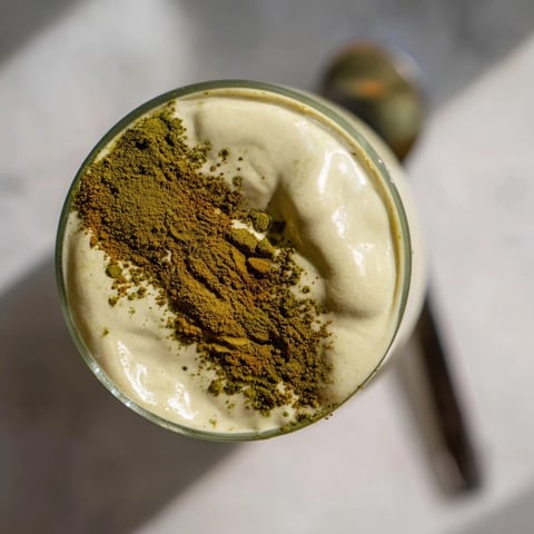 Matcha Eggnog Collagen Breakfast Smoothie, a vibrant green smoothie, creamy and frothy with nutmeg.