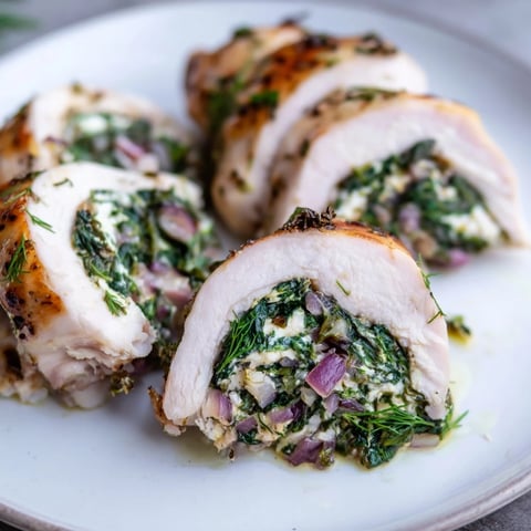 Spinach Feta Stuffed Chicken, golden brown from the oven, ready to serve with lemon.