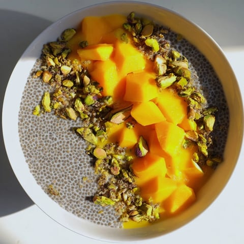 Creamy Mango Coconut Chia Pudding topped with toasted coconut and fresh mango chunks.