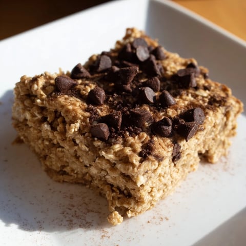 Golden brown Baked Oats That Taste Like Cake, square cut, smelling of vanilla and banana and ready to eat.