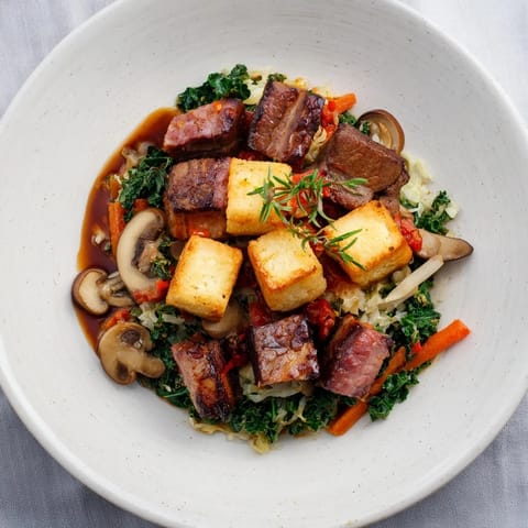 Rich, dark-colored Sriracha Bigos Fusion with a vibrant chili-infused aroma and savory notes.