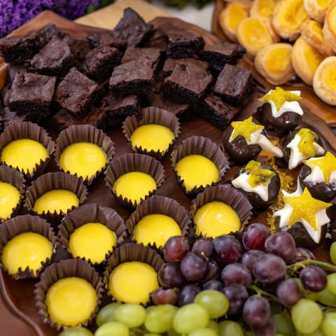 A glistening Star-Studded Dessert Board overflowing with chocolate-covered strawberries and fresh fruit pieces.