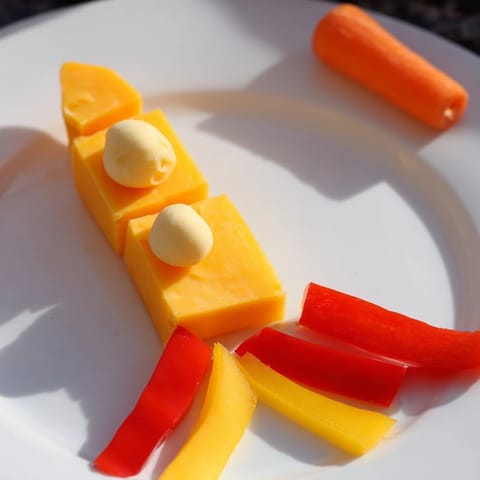 Vibrant Blast Off Spaceship Snack Board with colorful veggies, cheese, and a creamy ranch dip for dipping.