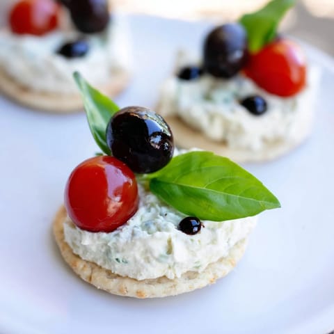 Vibrant Garden Snacks: Ladybug Tomato & Olive Bites, ready to be enjoyed as a whimsical snack.
