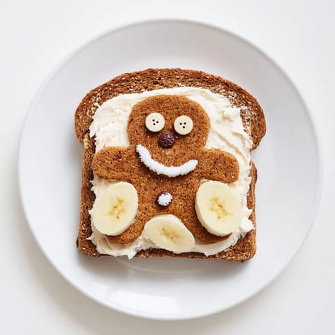 Sweet cream cheese filling inside Gingerbread Man sandwiches, garnished with raisins for eyes and smiles.