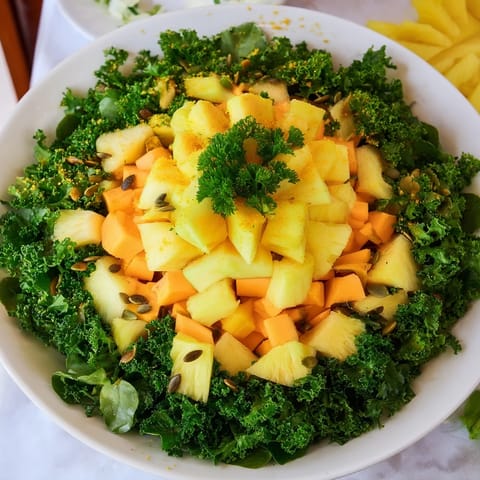 Fresh, colorful Sunlit Glade salad, a vegan delight with a sunny mix of fruits and fresh greens.
