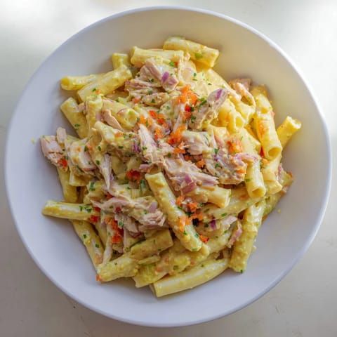 Close-up of Chicken Macaroni Holiday Salad, showcasing vibrant veggies and a creamy dressing.