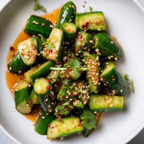 This close-up shows the refreshing Chinese Spicy Smashed Cucumber Salad, ready to be served and enjoyed.
