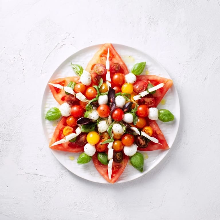Summer-ready Starfish Caprese Salad: A refreshing appetizer with colorful cherry tomatoes and fresh basil.