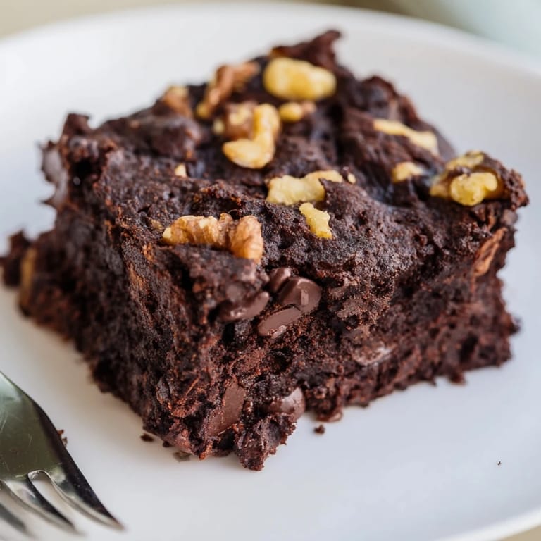 A plate of homemade black bean brownies, offering a naturally gluten-free yet satisfying treat.