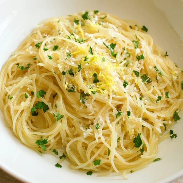 Delicate angel hair pasta coated in a zesty lemon sauce; this Lemon Capellini looks so delicious.
