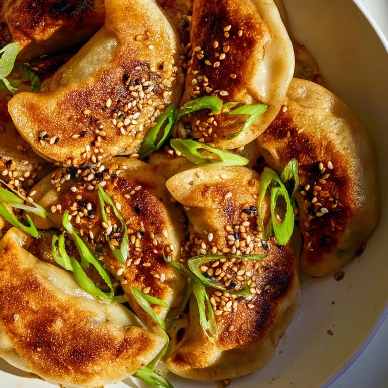Tender, perfectly cooked air fryer frozen dumplings bursting with flavorful fillings, topped with sesame seeds.