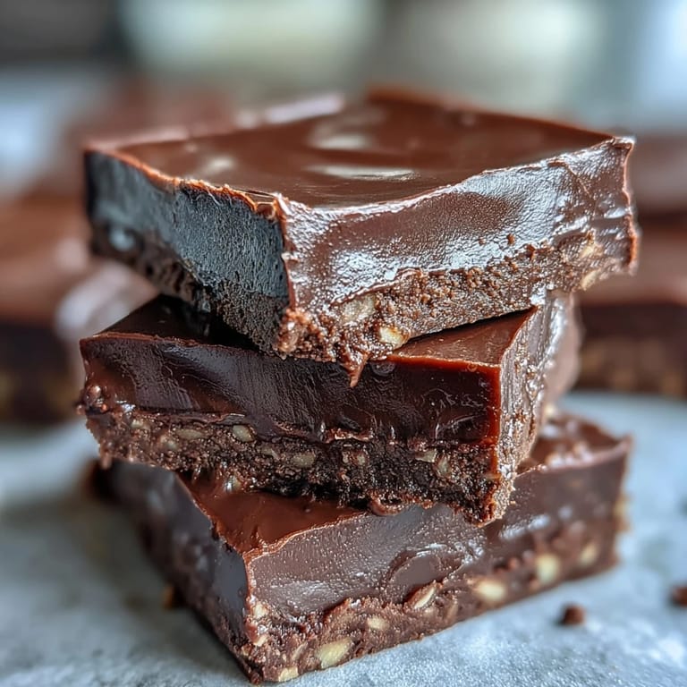 Fudgy Hojicha dessert squares on a white plate, ready to serve with a warm cup of tea.