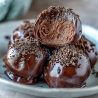Hojicha Truffles on a platter, dusted with roasted green tea powder, offering a refined after-dinner treat.